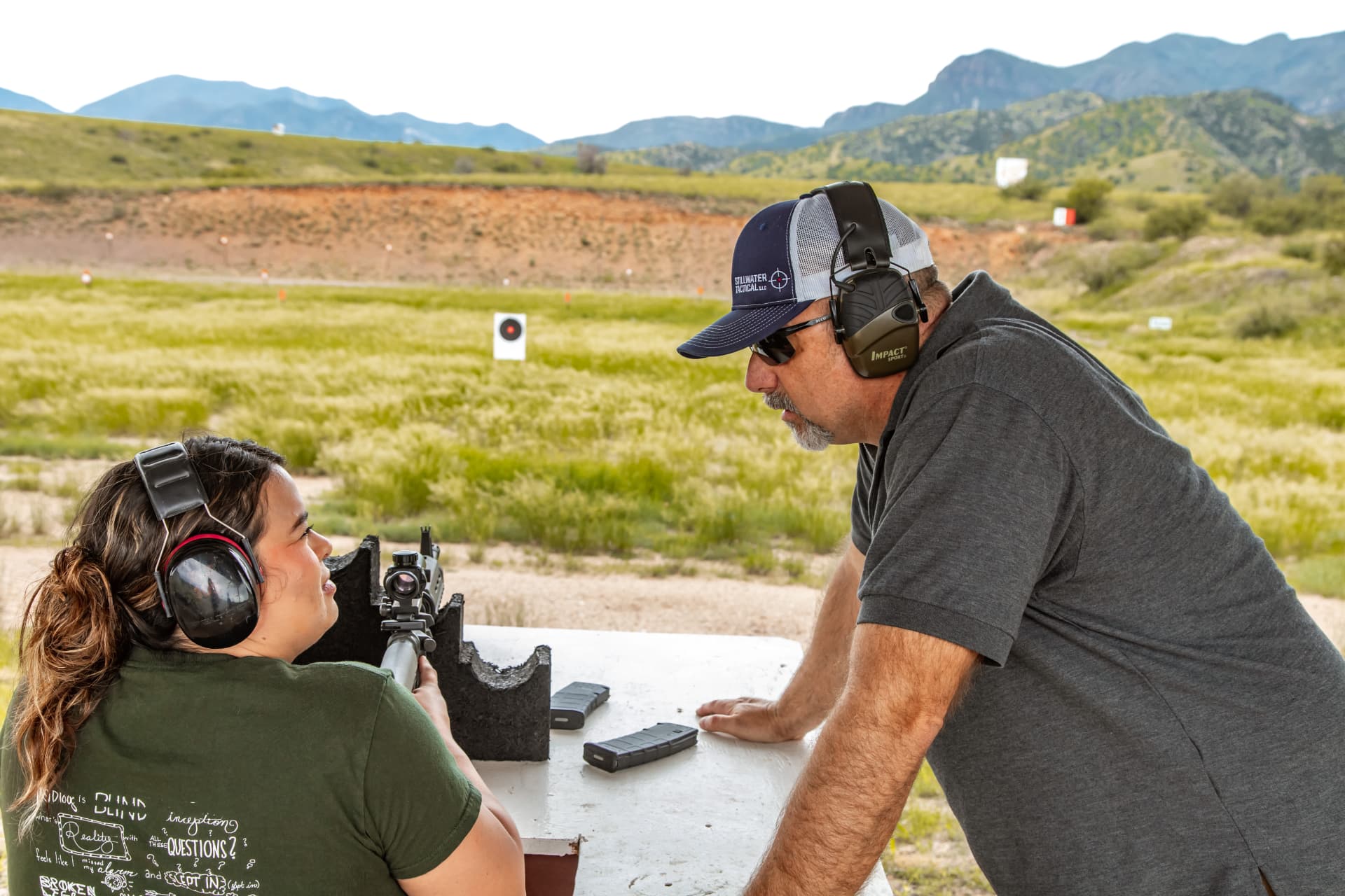Stillwater Tactical instructor coaching a student on rifle fundamentals at a Southern Arizona range
